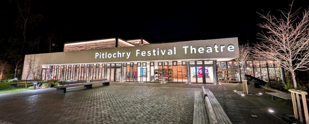 A photograph of the front entrance of Pitlochry Festival Theatre at Night.